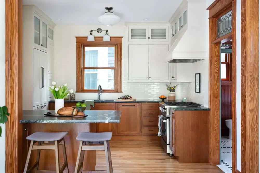 Kitchen remodeling Portland: 1902 NW Craftsman kitchen with stained wood lower cabinets, soapstone peninsula, white uppers and original-style fir trim