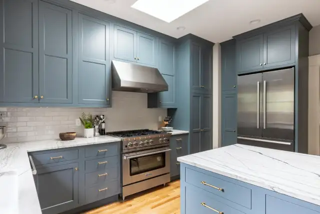 1913 Hawthorne kitchen remodel in Portland with blue painted cabinets, quartzite countertops, skylight and stainless range