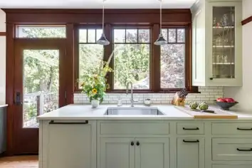 1916 Richmond Craftsman whole house remodel in Portland with sage green cabinets, wood-trimmed windows and a farmhouse sink