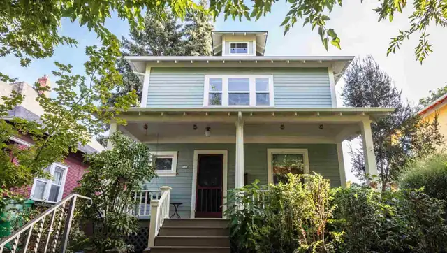 1906 SE Portland cottage addition with green siding, covered front porch and restored foursquare roofline